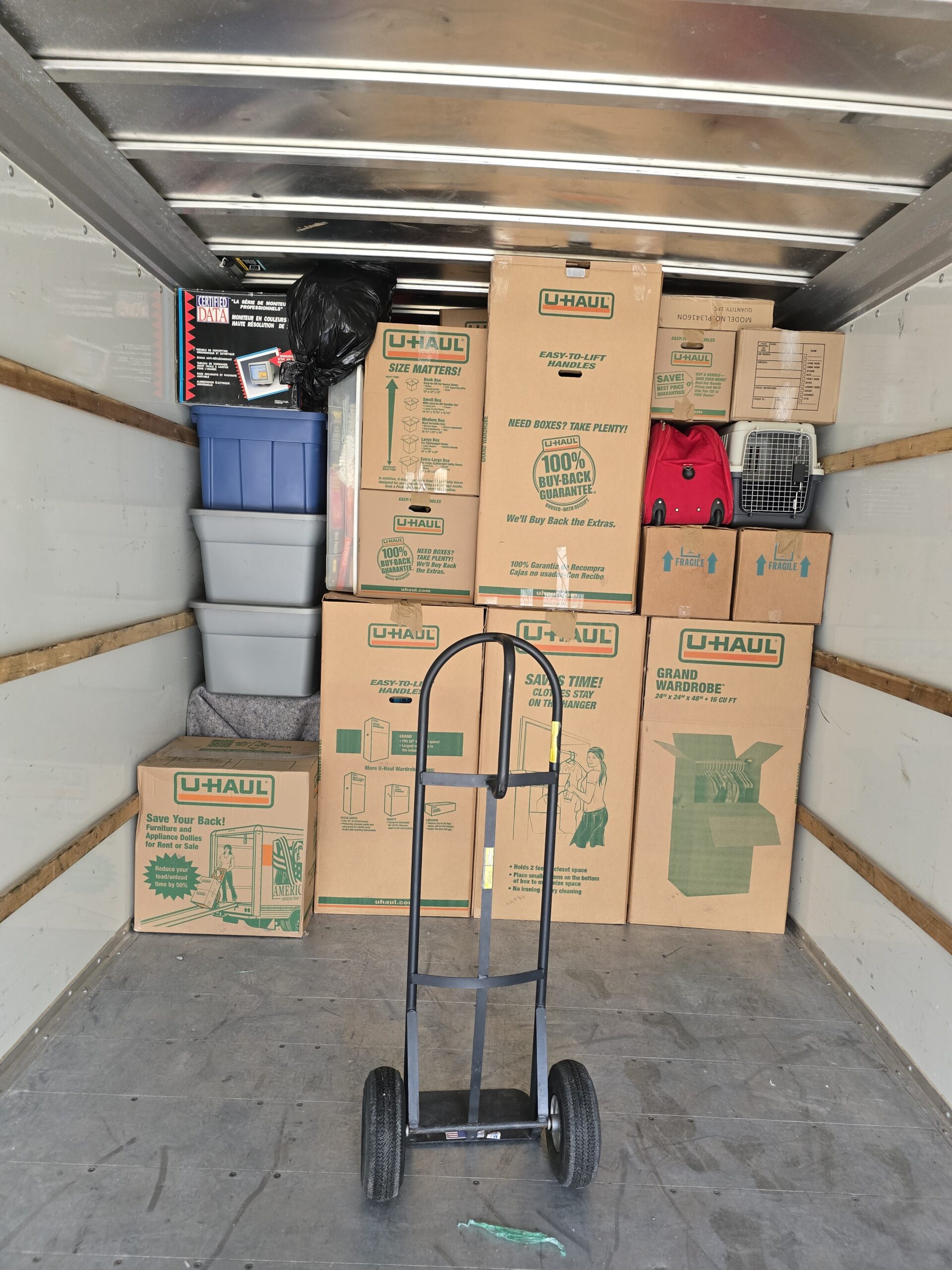 Loaded moving boxes and items inside a moving truck